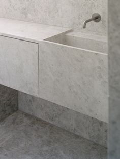 a bathroom with marble walls and floor