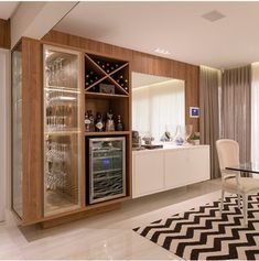 a dining room with a glass table and wine rack