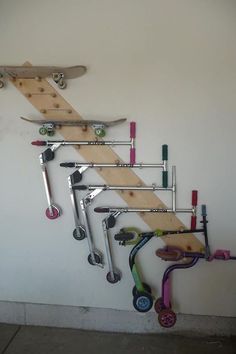 there is a skateboard rack on the wall with many different things attached to it