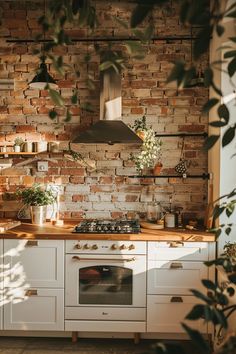 a kitchen with brick wall and white cabinets