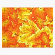 an orange and yellow puzzle with leaves on it