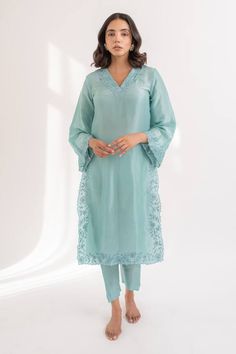 Tiffany blue kurta crafted in upada silk with flared sleeves and resham cutwork embroidery on the neckline, sleeves, front slits.
Components: 2
Pattern: Embroidered
Type Of Work: Resham
Neckline: V Neck
Sleeve Type: Flared
Fabric: Upada Silk
Color: Blue
Other Details: 
Side slits
Length:
Kurta: 44 inches
Pant: 36 inches
Closure:
Pant: Elastic band in the back
Occasion: Puja - Aza Fashions Blue Organza Kurta With Dabka Details, Blue Organza Kurta With Dabka Embroidery, V Neck Kurta, Blue Kurta, Best Summer Dresses, Cutwork Embroidery, Silk Kurta, Kurta With Pants, Online Dress Shopping