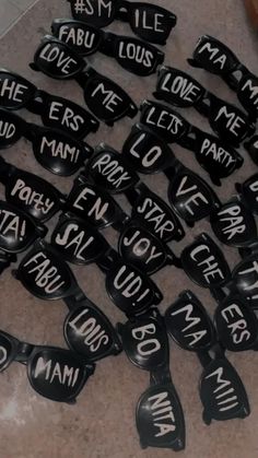 many black spoons with words on them sitting on the floor next to each other