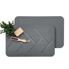 two placemats with a plant and a wooden spatula on top of them