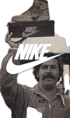 a man holding up a pair of shoes on top of his head with the words nike above him