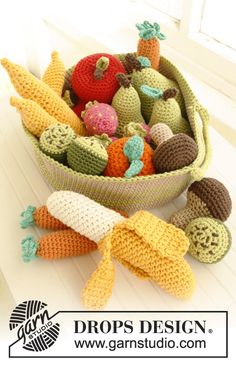 a crocheted basket filled with lots of different types of fruit and veggies