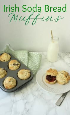 muffins are sitting on a plate next to a glass of milk