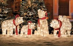 lighted polar bears in front of a christmas tree with snow on the ground and trees behind them