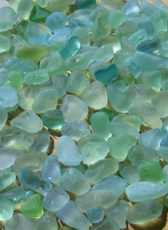 sea glass chips sitting on top of a wooden table