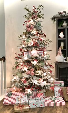 a decorated christmas tree with presents under it