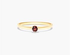 This 1.8mm petite single garnet birthstone ring in 14K yellow gold is a beautiful and elegant piece of jewelry. It is made of high-quality gold and features a small, sparkling garnet gemstone. The ring is also available in a variety of birthstones, so you can choose the perfect one for your loved one. This ring is a great option for stacking with other rings, creating a unique and fashionable look. If you are looking for a stylish and versatile piece of jewelry, then this 14K yellow gold 1.8mm p