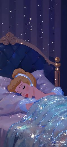 a woman laying in bed under a blanket with stars on the sheets and headboard