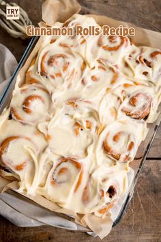 cinnamon rolls in a glass baking dish on a wooden table