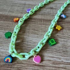 This lucky charms necklace will spread the luck of the Irish on Paddy's and year round. Each necklace will be uniquely handmade with a set of (8) lucky charms made out of acrylic. Share one with the little lucky charm in your life. The charms are fastened to plastic chain links, and finished off with a gold-plated lobster clasp. Each necklace will measure ~18". There will be variations in charms and colors due to the handmade nature and what's in stock, but send requests our way, and we'll do ou Green Good Luck Charms Necklace, Cute Handmade Plastic Necklace, Green Fun Plastic Jewelry, Fun Green Plastic Jewelry, Playful Green Plastic Jewelry, Green Charm Necklaces With Chain As A Gift, Green Chain Charm Necklaces As Gift, Lucky Charms Aesthetic, Ornament Tags