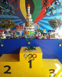 an olympic themed dessert table with cake and decorations