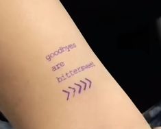 a person with a tattoo on their arm saying goodbyes are bitterer and an arrow