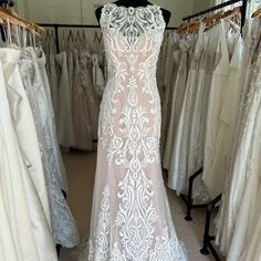 wedding gowns are displayed in a bridal shop