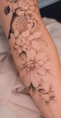 a woman's arm with flowers on it