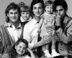 an old black and white photo of a family posing for the camera with one child