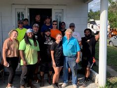 a group of people standing in front of a house