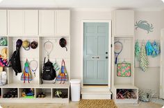 a room filled with lots of different types of shoes and handbags hanging on the wall