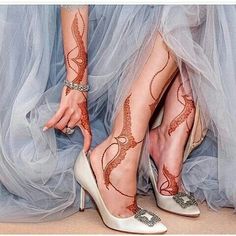 the legs and feet of a woman in high heels with hendix on them