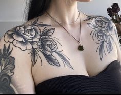 a woman with tattoos on her chest and shoulder