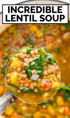 a spoon full of lentil soup with spinach and carrots