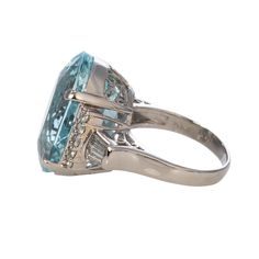 From our estate and antique collection, this vintage ring features an oval aquamarine center prong set in a platinum mounting with side round and baguette diamond accents. Aquamarine Total Weight: 17.99 ct Diamond Total Weight: 0.65 ct Ring Size: 6 This is a special piece of jewelry from our estate collection. We hope you will enjoy the character and imperfections that are associated with a vintage item. Platinum Diamond Rings, Platinum Ring, Baguette Diamond, Vintage Ring, Antique Collection, Prong Setting, Aquamarine, Vintage Rings, Platinum