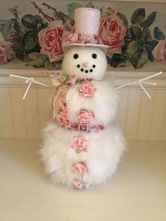 a snowman made out of fake fur and flowers