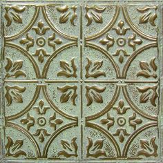 an old tin ceiling tile with decorative designs