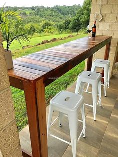 three white stools sitting on top of a wooden table