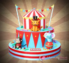 a circus themed cake with animals on top