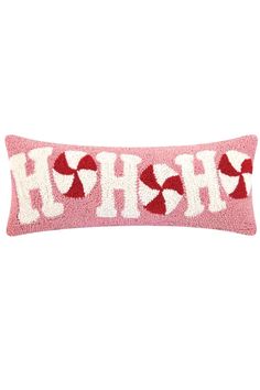 a pink and white pillow with the word h is for heart on it