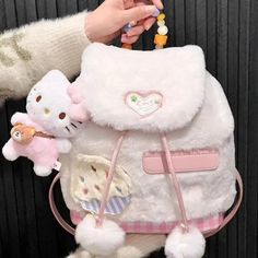 Pink Heart Plush Backpack - KimiThis adorable backpack is perfect for carrying your essentials with a sweet touch. The plush pink heart design adds a cute and playful element to any outfit. Stay organized on the go while showing off your lovable side. Cute Hello Kitty Bag, Sanrio Backpack, Funky Purses, Kawaii Store, Heart Plush, Bride Floral, Plush Backpack, Hello Kitty Items, Cute Backpacks