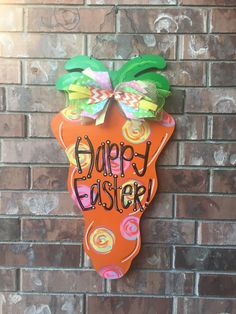 a sign that says happy easter hanging on a brick wall