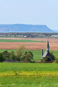 a small church in the middle of a field