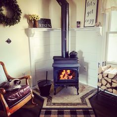 a living room with a wood stove and chair