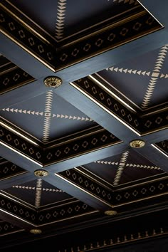 the ceiling is decorated with gold and black geometric designs, along with other decorative items