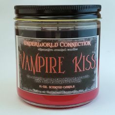 a jar of vampire kiss scented candles on a white table with a black lid and the words underworld connection