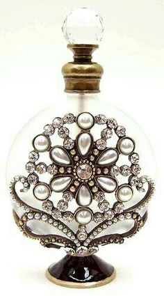 a bottle that has some kind of decoration on it's top and is filled with pearls