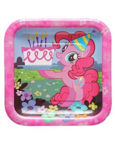 a pink pony birthday cake plate with candles on it's face and flowers around the edges