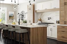 a kitchen with an island and bar stools next to the counter top in front of a window