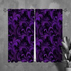 purple curtains hanging on the side of a wall next to a plant in a vase