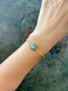 21 ct gold plated brass. Labradorite semi-precious stone Free size  Designed by our Turkish designer. Handcrafted with great care. Due to this is semi-precious stone, they might have cracks. Size and Color slightly differ from what you see on your screen. We will send within 3 working days! Dainty Brass Bracelet As Gift, Dainty Brass Bracelet For Gifts, Dainty Brass Bracelet For Gift, Dainty Gold-plated Gemstone Bracelets, Gold-plated Stackable Cuff Bracelet As Gift, Gold Cuff Bracelet With Natural Stones For Gift, Dainty Brass Bangle Jewelry, Gold Plated Stackable Cuff Bracelet As A Gift, Gold Plated Stackable Cuff Bracelet For Gifts