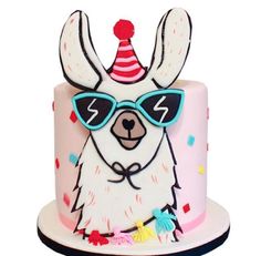 a cake with a llama wearing sunglasses and a party hat on it's head