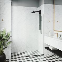 a bathroom with a black and white checkerboard floor, large mirror, shower stall and sink