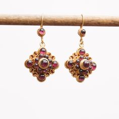 Garnet set on 24k vermeil Mandala design earring. Vermeil on silver ear wire Approximate Dimensions : L 1.5 X W0.75 Inches Gold Gemstone Cluster Drop Earrings, Yellow Gold Byzantine Earrings Gift, Gold Hallmarked Cluster Drop Earrings, Byzantine Style Pierced Drop Earrings, Byzantine Jewelry With Matching Earrings For Anniversary, Byzantine Style Gemstone Earrings Gift, Byzantine Gemstone Earrings Gift, Byzantine Sterling Silver Jewelry With Matching Earrings, Byzantine Style Pierced Earrings As Gift