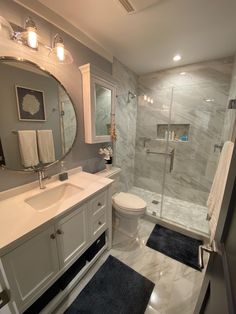 a bathroom with a sink, toilet and shower