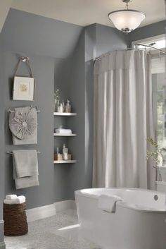 a bathroom with gray walls and white fixtures